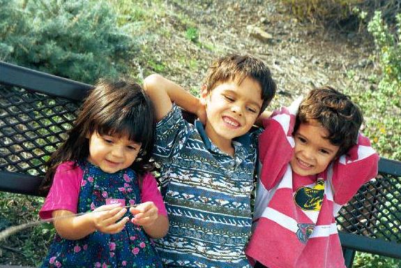 Jasmine, Paul, and Daniel sitting on a bench
